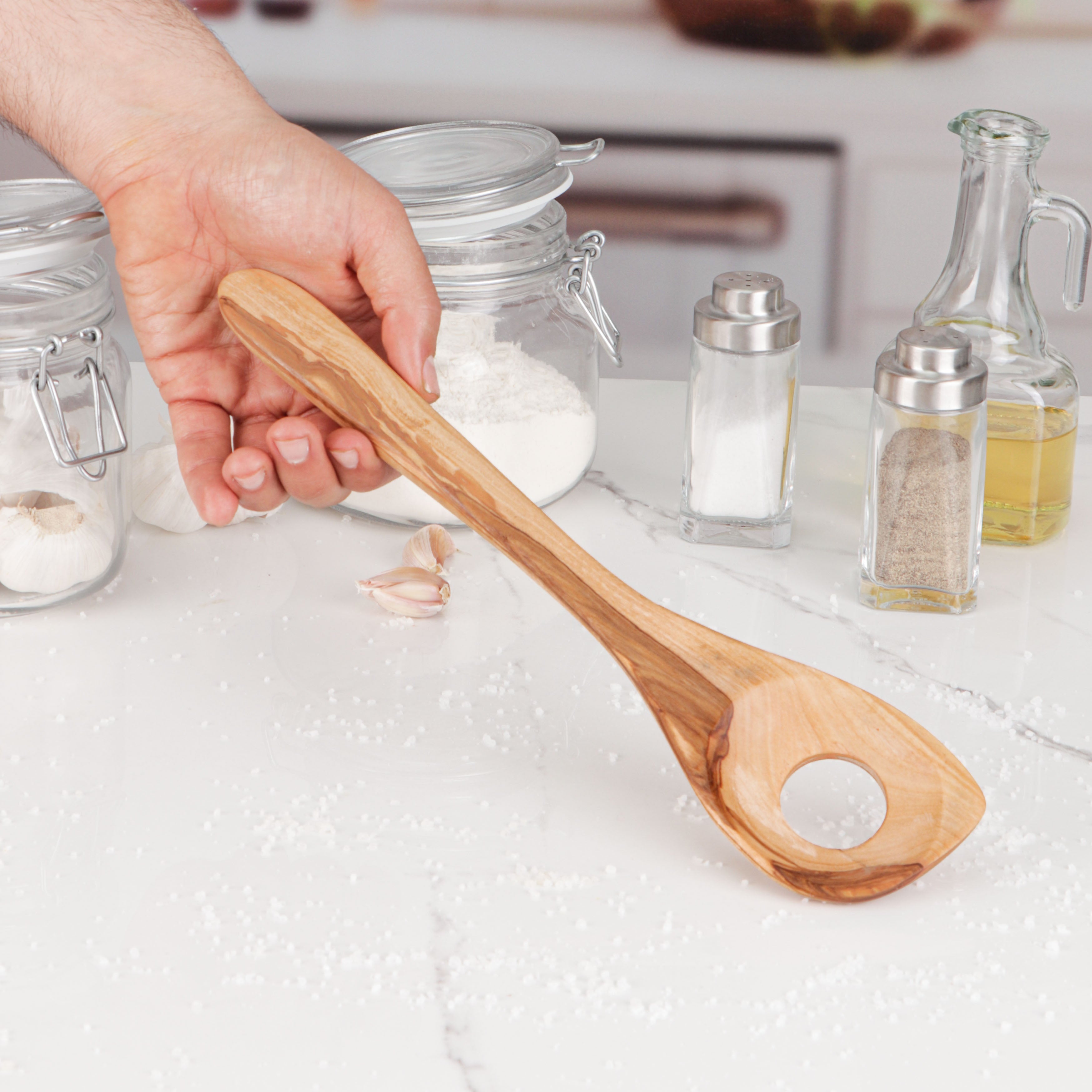 Durable and versatile olive wood cooking spoon, specifically designed for risotto but suitable for various cooking tasks. The ergonomic design and smooth finish of this hand-carved utensil make it comfortable for stirring, mixing, and serving. Revel in the natural beauty and unique patterns of olive wood that add a touch of warmth to your kitchen, ensuring no two spoons are alike, making each use a joy.